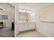 This bathroom features a double vanity with white cabinets, a large mirror, and a beige tile floor at 332 Sinclair Ct # 77, Mcdonough, GA 30253