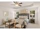 Luxurious bedroom features a tufted headboard, tray ceiling, and stylish seating area at 332 Sinclair Ct # 77, Mcdonough, GA 30253