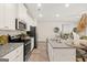 Open kitchen with stainless steel appliances and a center island featuring barstool seating at 332 Sinclair Ct # 77, Mcdonough, GA 30253