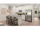 Modern kitchen with white cabinets, stainless steel appliances, and a granite island at 332 Sinclair Ct # 77, Mcdonough, GA 30253