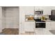 Bright kitchen with granite countertops, white cabinets, and stainless-steel appliances at 332 Sinclair Ct # 77, Mcdonough, GA 30253