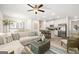 Open-concept living room flows into kitchen with white cabinets and stainless steel appliances at 332 Sinclair Ct # 77, Mcdonough, GA 30253