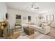 Bright living room featuring a plush sofa, ceiling fan, and access to the dining area at 332 Sinclair Ct # 77, Mcdonough, GA 30253