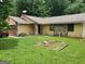 Ranch-style home with yellow siding, stone accents, and a well-maintained lawn at 259 Independence Dr, Jonesboro, GA 30238