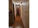 Narrow hallway with hardwood flooring, multiple doors, and decorative wall decal at 259 Independence Dr, Jonesboro, GA 30238
