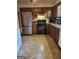 Traditional kitchen featuring stainless steel refrigerator, oven, and wooden cabinets at 259 Independence Dr, Jonesboro, GA 30238