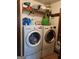 The laundry room showcasing a white LG washer and dryer, with storage shelf above at 259 Independence Dr, Jonesboro, GA 30238