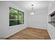 Bright dining room with modern lighting and view to the exterior greenery at 843 Seasons Pkwy, Norcross, GA 30093