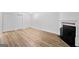 Open-concept living room with laminate floors, fireplace, and ample natural light at 843 Seasons Pkwy, Norcross, GA 30093