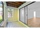 Enclosed patio with wood floorboards and view to bedroom at 843 Seasons Pkwy, Norcross, GA 30093