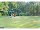 Community playground with colorful equipment, set against a lush green backdrop at 843 Seasons Pkwy, Norcross, GA 30093
