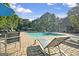Community swimming pool with lush trees and green space at 843 Seasons Pkwy, Norcross, GA 30093
