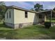 A well-kept home features a solid foundation and a charming covered porch area at 323 Hollonville Rd, Brooks, GA 30205