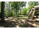 A backyard featuring a fire pit and a wooden deck, perfect for entertaining guests on summer nights at 85 Eastwood Frst, Covington, GA 30014