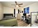 Well-lit bedroom featuring a ceiling fan, wood floors, and a workspace at 85 Eastwood Frst, Covington, GA 30014