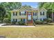 Charming two-story home with a brick-lined entryway and a well-manicured front yard at 85 Eastwood Frst, Covington, GA 30014