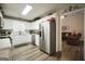 Bright kitchen with white cabinets, stainless steel appliances, and laminate flooring at 85 Eastwood Frst, Covington, GA 30014