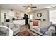 Living room featuring a ceiling fan, hardwood floors, and lots of seating at 85 Eastwood Frst, Covington, GA 30014