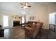 Inviting living room with a brick fireplace, ceiling fan, and comfortable seating at 85 Eastwood Frst, Covington, GA 30014