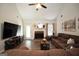 Inviting living room with a brick fireplace, ceiling fan, and comfortable seating at 85 Eastwood Frst, Covington, GA 30014