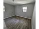 This spacious bedroom features wood-look flooring and two bright windows for great natural light at 2934 Harris St, East Point, GA 30344