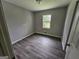 Cozy bedroom with new flooring, neutral paint, and natural light from the window at 2934 Harris St, East Point, GA 30344