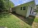 The home's exterior features a brick finish, lush lawn, and fenced yard at 2934 Harris St, East Point, GA 30344