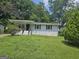 Charming single-story home with black trim, freshly cut lawn, and mature shade trees at 2934 Harris St, East Point, GA 30344