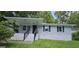 Inviting single-story home with black trim, covered porch, and manicured lawn at 2934 Harris St, East Point, GA 30344