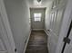 A tidy laundry room with wood flooring and window for natural light and included upper rack at 2934 Harris St, East Point, GA 30344