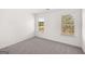 Neutral bedroom with carpeted floors and two bright windows offering natural light at 683 Edgar, Hampton, GA 30228
