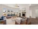 Inviting living room boasts large windows, comfortable seating, and stone fireplace at 683 Edgar, Hampton, GA 30228