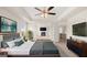 Spacious main bedroom features tray ceiling, fan, seating area with fireplace, and ensuite bath at 683 Edgar, Hampton, GA 30228