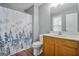 Well-lit bathroom with a toilet, shower-tub combo with shower curtain, and single vanity at 2203 Hyssop Way, Buford, GA 30519