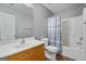 Well-lit bathroom featuring a single sink vanity, toilet, and a shower-tub combination with a curtain at 2203 Hyssop Way, Buford, GA 30519