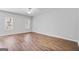 Sunlit bedroom with hardwood floors, neutral walls, and large windows at 2203 Hyssop Way, Buford, GA 30519