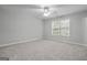 Bright bedroom with a ceiling fan, a window with blinds, and neutral carpeting at 2203 Hyssop Way, Buford, GA 30519
