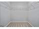 Walk-in closet with shelving and neutral carpeting at 2203 Hyssop Way, Buford, GA 30519
