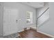 Bright foyer featuring hardwood floors, a staircase, and a front door with natural light at 2203 Hyssop Way, Buford, GA 30519