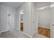 Upstairs hallway with carpet that leads to a bathroom and other bedrooms at 2203 Hyssop Way, Buford, GA 30519