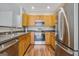 Modern kitchen featuring stainless steel appliances, hardwood floors, and plenty of cabinet space at 2203 Hyssop Way, Buford, GA 30519
