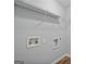 Utility room with shelving, wood-look floors and plumbing hookups for a washer and dryer at 2203 Hyssop Way, Buford, GA 30519