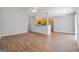 Bright living room featuring hardwood floors, ceiling fan and a view into the kitchen at 2203 Hyssop Way, Buford, GA 30519