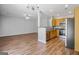 Open-concept view of the living room and kitchen with modern appliances and hardwood floors at 2203 Hyssop Way, Buford, GA 30519