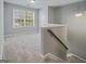 Upstairs loft featuring neutral paint and carpet, natural light, and stairwell at 2203 Hyssop Way, Buford, GA 30519