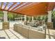 Outdoor lounge area with wicker couches and chairs near the pool, covered by a pergola at 2203 Hyssop Way, Buford, GA 30519