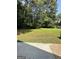Spacious backyard with green grass and a storage shed, providing ample outdoor space for activities at 4688 Brice Dr, Union City, GA 30291