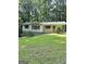 Charming home featuring a covered porch, green metal roof, and mature trees surrounding the property at 4688 Brice Dr, Union City, GA 30291
