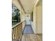 Covered front porch with wood flooring and a wooden railing leads to the white front door at 4688 Brice Dr, Union City, GA 30291