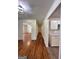 Hallway with hardwood floors, kitchen cabinets on the right, and living room on the left at 4688 Brice Dr, Union City, GA 30291